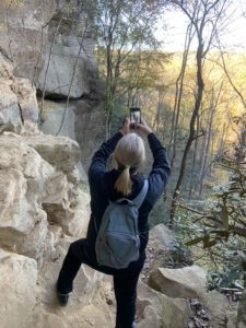 Hiker takes photo of Kentucky landscape. Website design Georgetown KY focus.